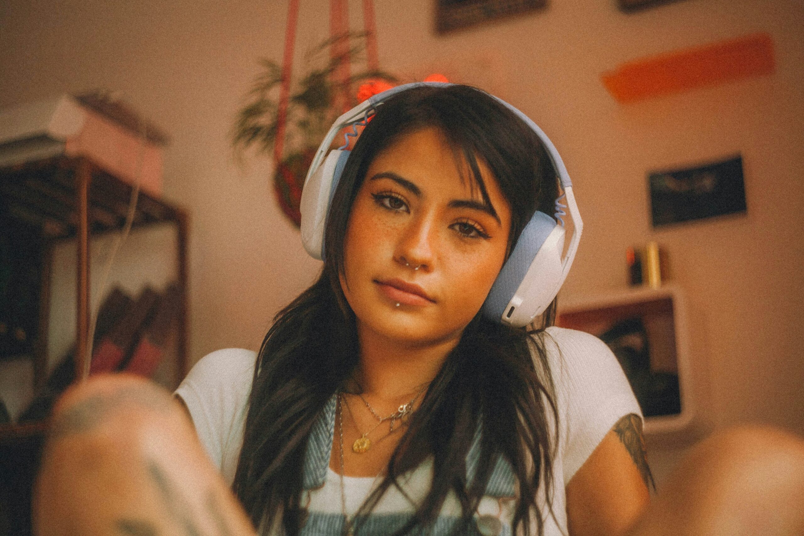A player wearing gaming headphones to listen for Fortnite audio cues.