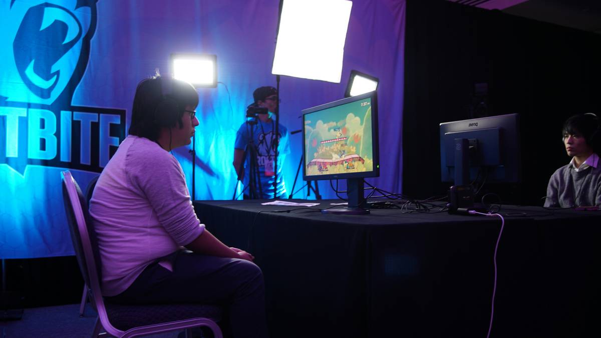 Bugha celebrating his victory at the Fortnite World Cup Final 2019 with fireworks exploding behind him.