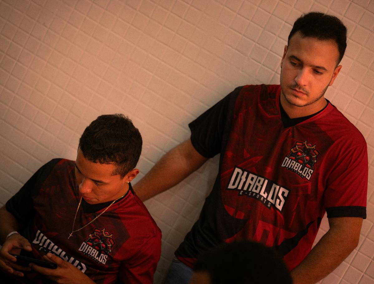 A professional Fortnite player wearing headphones and intensely focusing on their game