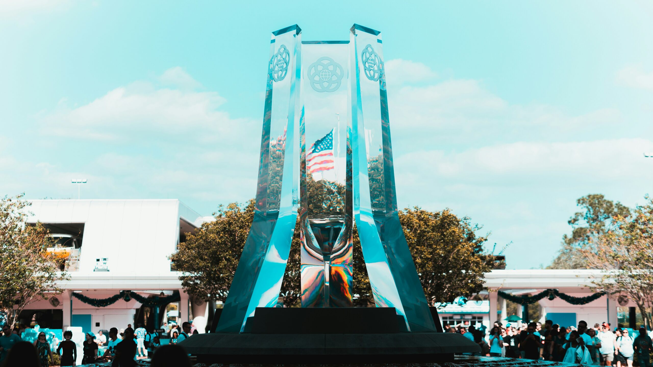 a large crowd of people outside a building with a large statue